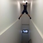 guy changing light bulb in high staircase dangerous