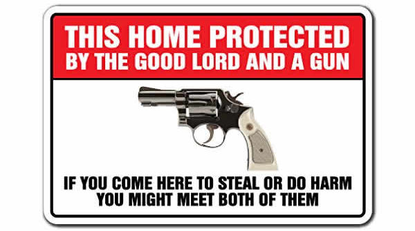 funny sign protected by the good lord and a gun